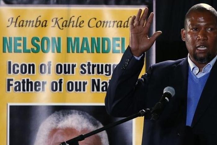 Former South African President Nelson Mandela's grandson Mandla addresses a speech during a send-off ceremony for Nelson Mandela at Waterkloof Air Force base in Pretoria December 14, 2013. REUTERS/Yves Herman