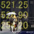 A woman clad in a kimono is reflected in an electronic board displaying Japan's Nikkei share average outside a brokerage in Tokyo, Japan, April 18, 2016.