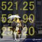 A woman clad in a kimono is reflected in an electronic board displaying Japan's Nikkei share average outside a brokerage in Tokyo, Japan, April 18, 2016.