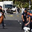 French police secure the area as the investigation continues at the scene near the heavy truck that ran into a crowd at high speed killing scores who were celebrating the Bastille Day July 14 national holiday on the Promenade des Anglais in Nice, Franc...