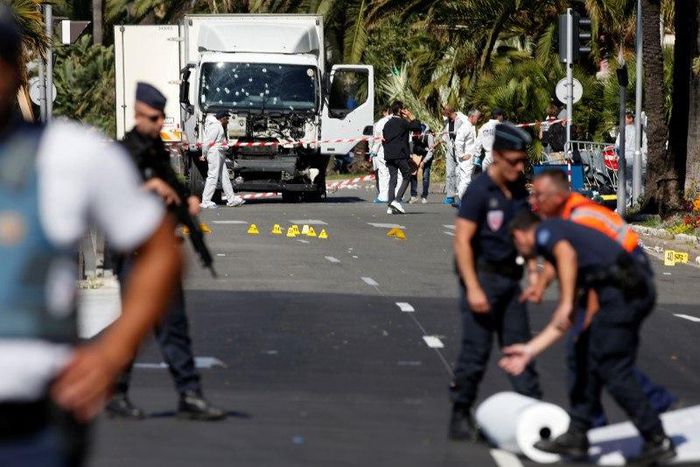 French police secure the area as the investigation continues at the scene near the heavy truck that ran into a crowd at high speed killing scores who were celebrating the Bastille Day July 14 national holiday on the Promenade des Anglais in Nice, Franc...