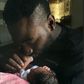 Gbenro Ajibade cradles his baby