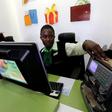 An employee uses a money counting machine as she serves a customer inside a mobile phone care centre operated by Kenyan's telecom operator Safaricom; in the central business district of Kenya's capital Nairobi, May 11, 2016.