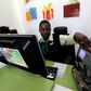 An employee uses a money counting machine as she serves a customer inside a mobile phone care centre operated by Kenyan's telecom operator Safaricom; in the central business district of Kenya's capital Nairobi, May 11, 2016.