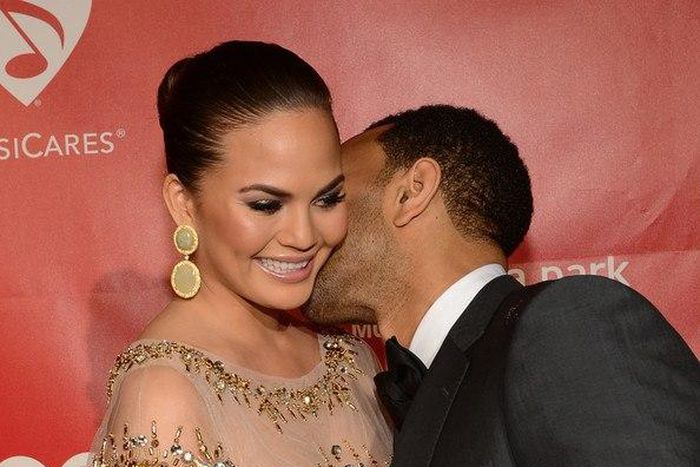 John Legend kissing his wife