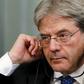 Italian Foreign Minister Paolo Gentiloni adjusts his headphones during a joint news conference with his Russian counterpart Sergei Lavrov following their meeting in Moscow, Russia, March 25, 2016.