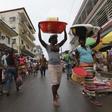 People walk along a street market in Monrovia October 13, 2011.