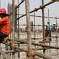 Chinese and Nigerien construction workers work on the site of an Islamic university in Niamey, Niger, February 22, 2016.