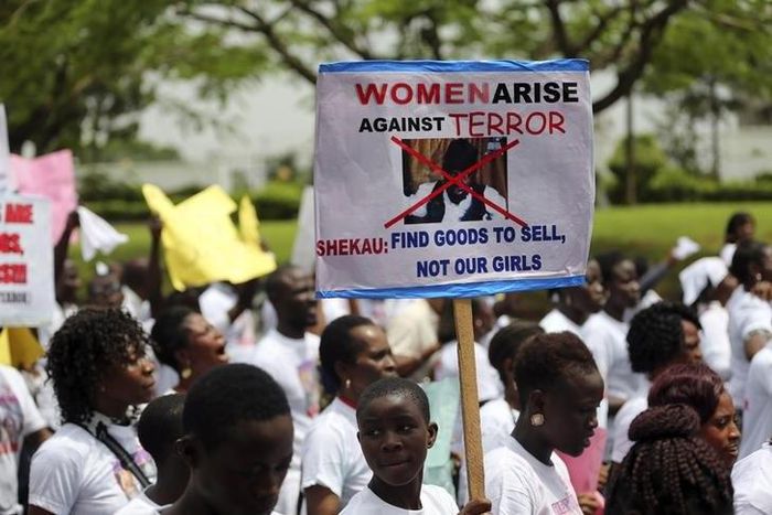 A student holds a sign with an image of Boko Haram leader?Abubakar?Shekau?as she protests for the release of the abducted secondary school girls in the remote village of Chibok, along a road in Lagos May 12, 2014.