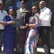 Musiliu Obanikoro flanked by his wife and children at his graduation