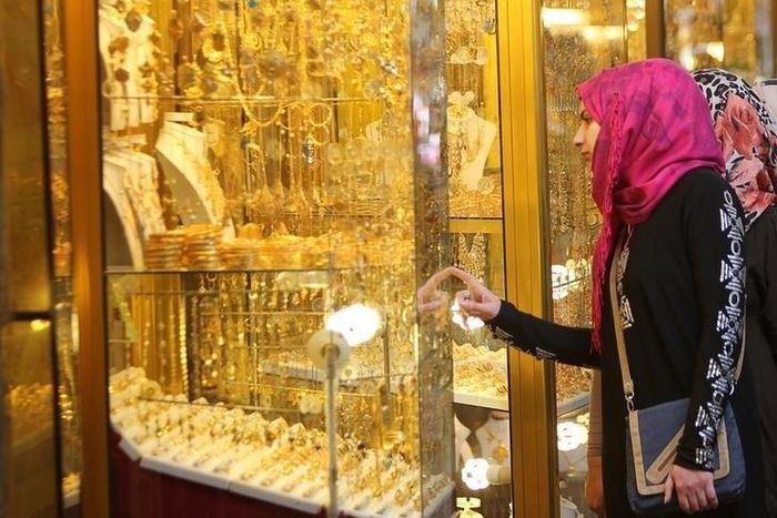 Women look at jewellery at a shop in a gold market in Basra, southeast of Baghdad February 14, 2015.