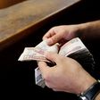 A customer counts his Egyptian 50 pound notes at an exchange office in downtown Cairo, Egypt, April 19, 2016. REUTERS/Amr Abdallah Dalsh