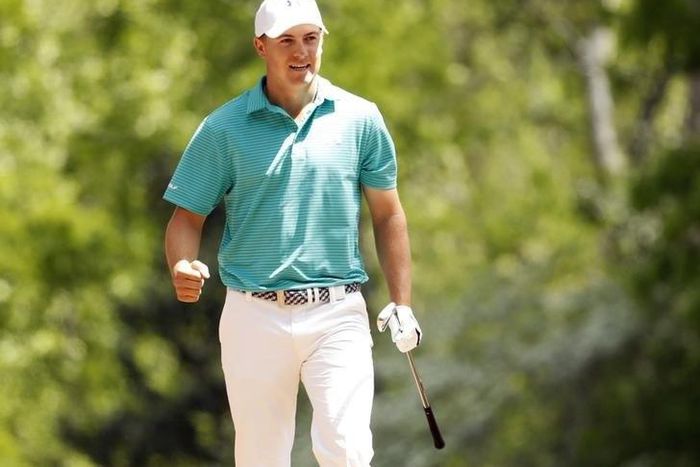 Jordan Spieth reacts after hitting from the straw on the 11th hole during the first round of the 2016 The Masters golf tournament at Augusta National Golf Club.