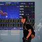 A man walks in front of a screen showing today's movements of Nikkei share average outside a brokerage in Tokyo, Japan, June 2, 2016.