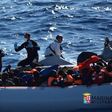 Migrants sit in their rubber dinghy during a rescue operation by Italian navy ship Borsini (unseen) off the coast of Sicily, Italy, in this handout picture courtesy of the Italian Marina Militare released July 19, 2016. Marina Militare/Handout via