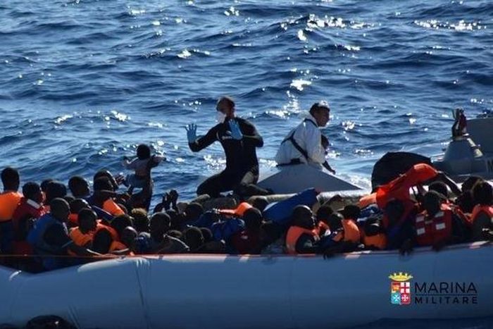Migrants sit in their rubber dinghy during a rescue operation by Italian navy ship Borsini (unseen) off the coast of Sicily, Italy, in this handout picture courtesy of the Italian Marina Militare released July 19, 2016. Marina Militare/Handout via