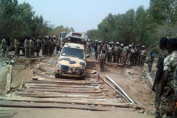 Nigerian troops are pictured in 2015 crossing a reconstructed bridge, previously destroyed by militants, in the northeastern town of Damasak 