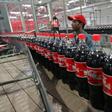 A worker checks bottles of Coca-Cola in Kabul September 10, 2006.