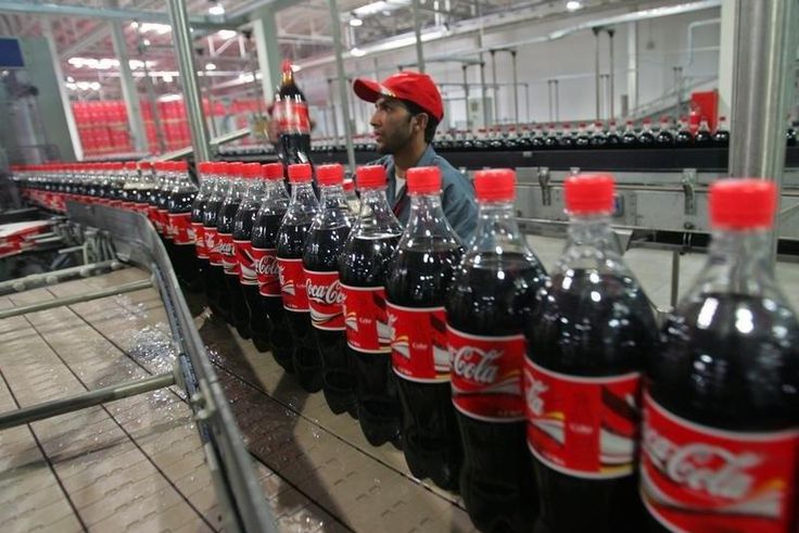 A worker checks bottles of Coca-Cola in Kabul September 10, 2006.
