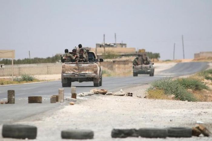 Syria Democratic Forces (SDF) ride vehicles along a road near Manbij, in Aleppo Governorate, Syria, June 25, 2016.