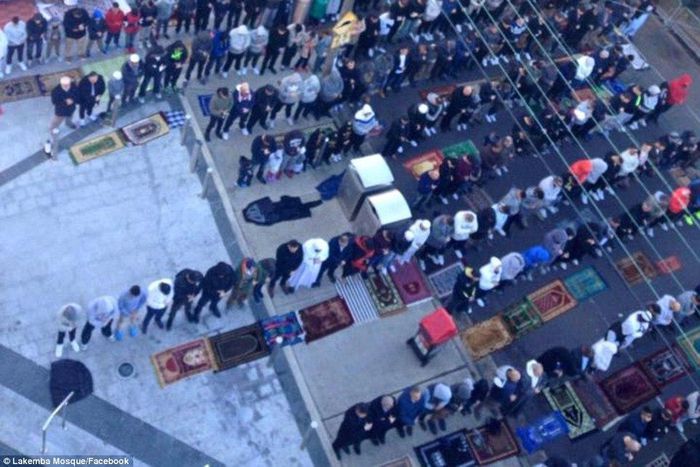 Muslims praying on the street, around the Mosque