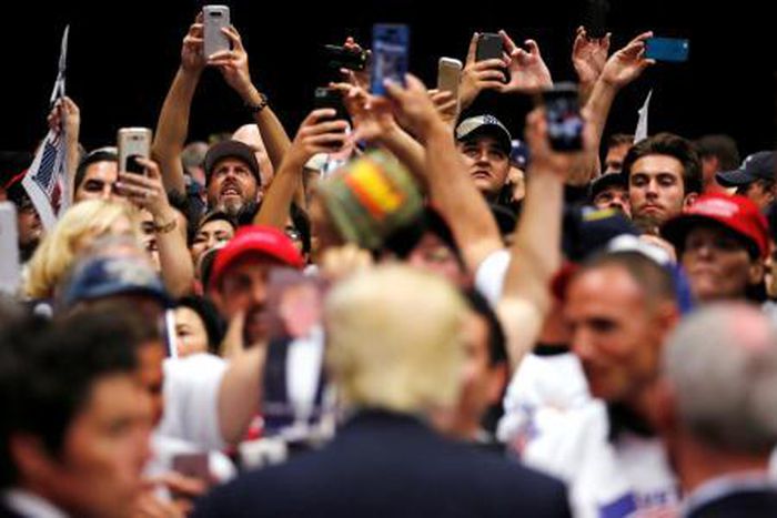 Republican U.S. presidential candidate Donald Trump signs autographs after a rally with supporters in San Diego, California, U.S. May 27, 2016.