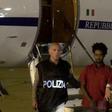 Medhanie Yehdego Mered (C), 35, is pictured with Italian policemen as they land at Palermo airport, Italy, following his arrest in Khartoum, Sudan, on May 24.   REUTERS/File Photo