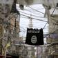 An Islamic State flag hangs amid electric wires over a street in Ain al-Hilweh Palestinian refugee camp, near the port-city of Sidon, southern Lebanon January 19, 2016.
