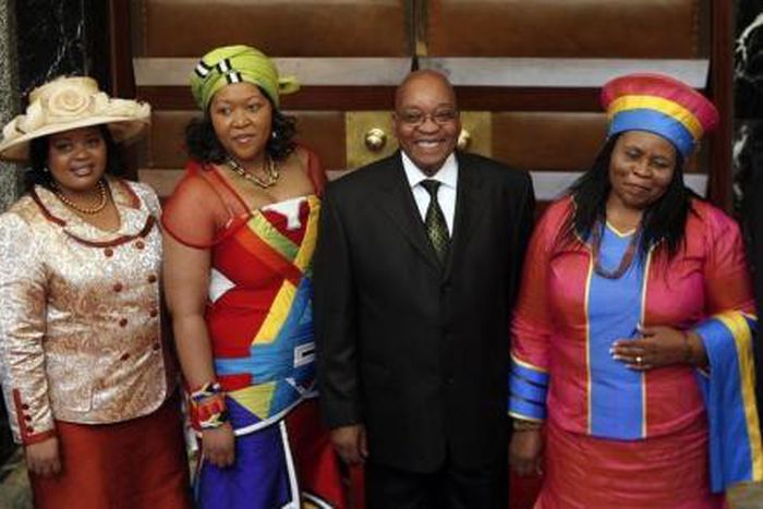 South African President Jacob Zuma poses for photographs with his three wives Sizakele Khumalo (R), Nompumelelo Ntuli (L) and Thobeka Mabhija after delivering his state-of-the-nation address in parliament in Cape Town.