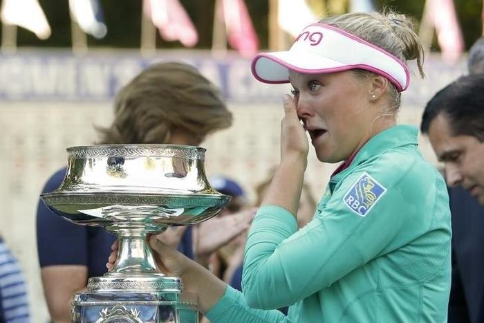 Jun 12, 2016; Sammamish, WA, USA; Brooke Henderson reacts after receiving the KPMG Women's PGA Championship trophy after a one-hole sudden death playoff against Lydia Ko (not pictured) during the final round at Sahalee Country Club - South/North Course...