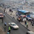 People queue as they wait for a commercial bus during the morning rush hour in Ojota district in Nigeria's commercial capital Lagos November 23, 2015.