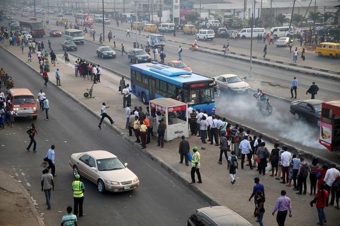 People queue as they wait for a commercial bus during the morning rush hour in Ojota district in Nigeria's commercial capital Lagos November 23, 2015.