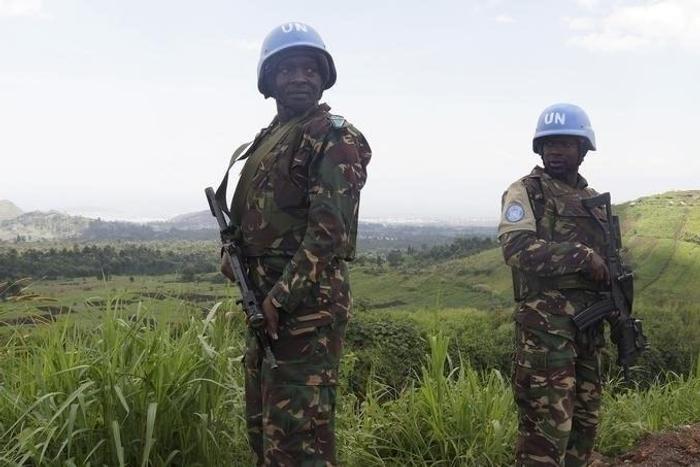 U.N. peacekeepers from Tanzania hold their weapons as they patrol outside Goma during a visit by officials from the U.N. Security Council in the eastern Democratic Republic of Congo, October 6, 2013.