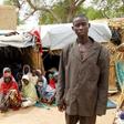 Aba Ali, a Nigerian refugee who fled from his village in northeastern Nigeria into Niger following Boko Haram attacks, stands next to his relatives at the home of Adamu Moumouni, his Nigerien host who took them in, in Diffa in southeastern Niger June 2...