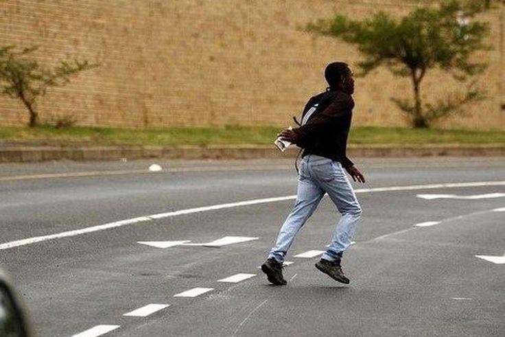 A man runs past the Adcock Ingram offices in Johannesburg December 3, 2013.