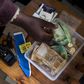 A shopkeeper puts money in her cash box at her shop in Hillcrest west of Durban, South Africa, January 11, 2016.