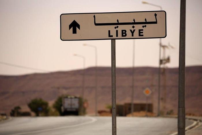 A road sign shows the direction of Libya near the border crossing at Dhiba, Tunisia April 11, 2016.