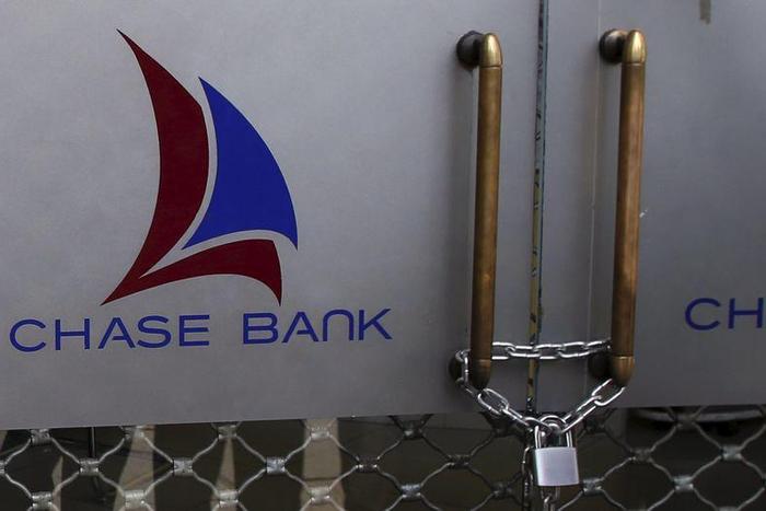 The logo of Chase Bank is seen on the closed entrance of one of its branches, after the bank was put under receivership, in Nairobi, Kenya, April 8, 2016. REUTERS/Siegfried Modola