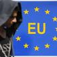A migrant walks next to an EU sign at the border with Serbia in Tovarnik, Croatia September 17, 2015. REUTERS/Antonio Bronic
