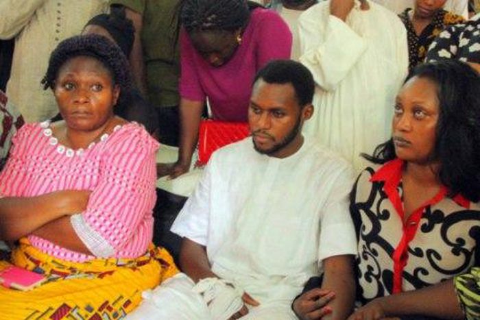 James Ocholi's surviving son, Aaron (middle).