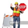 Traffic official flagging approaching car