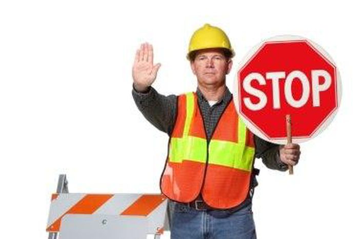 Traffic official flagging approaching car