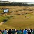 Angel Cabrera of Argentina and Camilo Villegas of Colombia mark their balls on the 16th green during the second round of the British Open golf Championship at Muirfield in Scotland July 19, 2013.