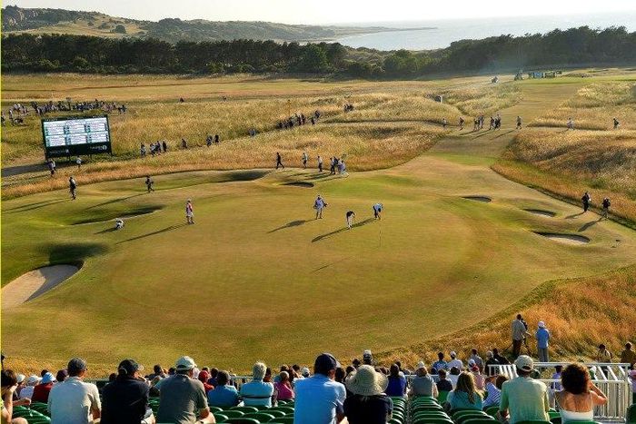 Angel Cabrera of Argentina and Camilo Villegas of Colombia mark their balls on the 16th green during the second round of the British Open golf Championship at Muirfield in Scotland July 19, 2013.