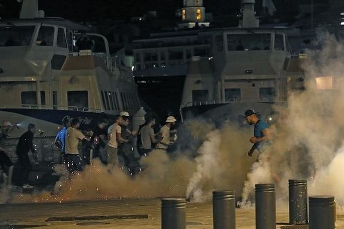 Police disperse revellers at the old port of Marseille after the England v Russia - Group B match.