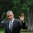 U.S. President Barack Obama waves as he walks under a rain on the South Lawn of the White House upon his return to Washington, U.S., after visiting wounded service members the Walter Reed National Military Medical Center, June 21, 2016. REUTERS/Yuri Gr...