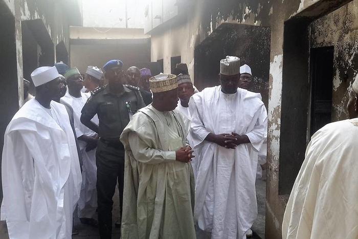 Tambuwal being shown round the burnt house by the Sokoto State chairman of the PDP, Alhaji Ibrahim Milgoma.