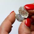 A 30-carat and a 14-carat rough diamond, initially one piece, are viewed after they have been split at the offices of a polishing factory in Antwerp, Belgium, April 28, 2016.