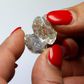 A 30-carat and a 14-carat rough diamond, initially one piece, are viewed after they have been split at the offices of a polishing factory in Antwerp, Belgium, April 28, 2016.