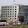 People and vehicles are seen in front of the National Bank of Egypt (NBE), also known as the Al Ahli Bank, in the Fifth Settlement districts of New Cairo March 30, 2013. REUTERS/Amr Abdallah Dalsh
